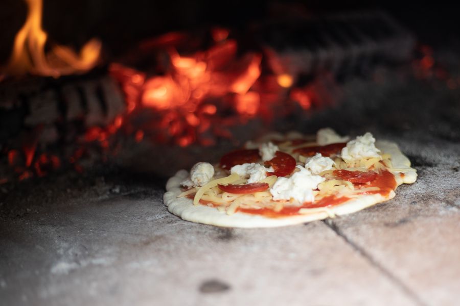 Woodfired pizza in the oven at Worship Worth Experiences